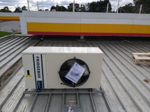 Mounted_outdoor_unit_into_postion